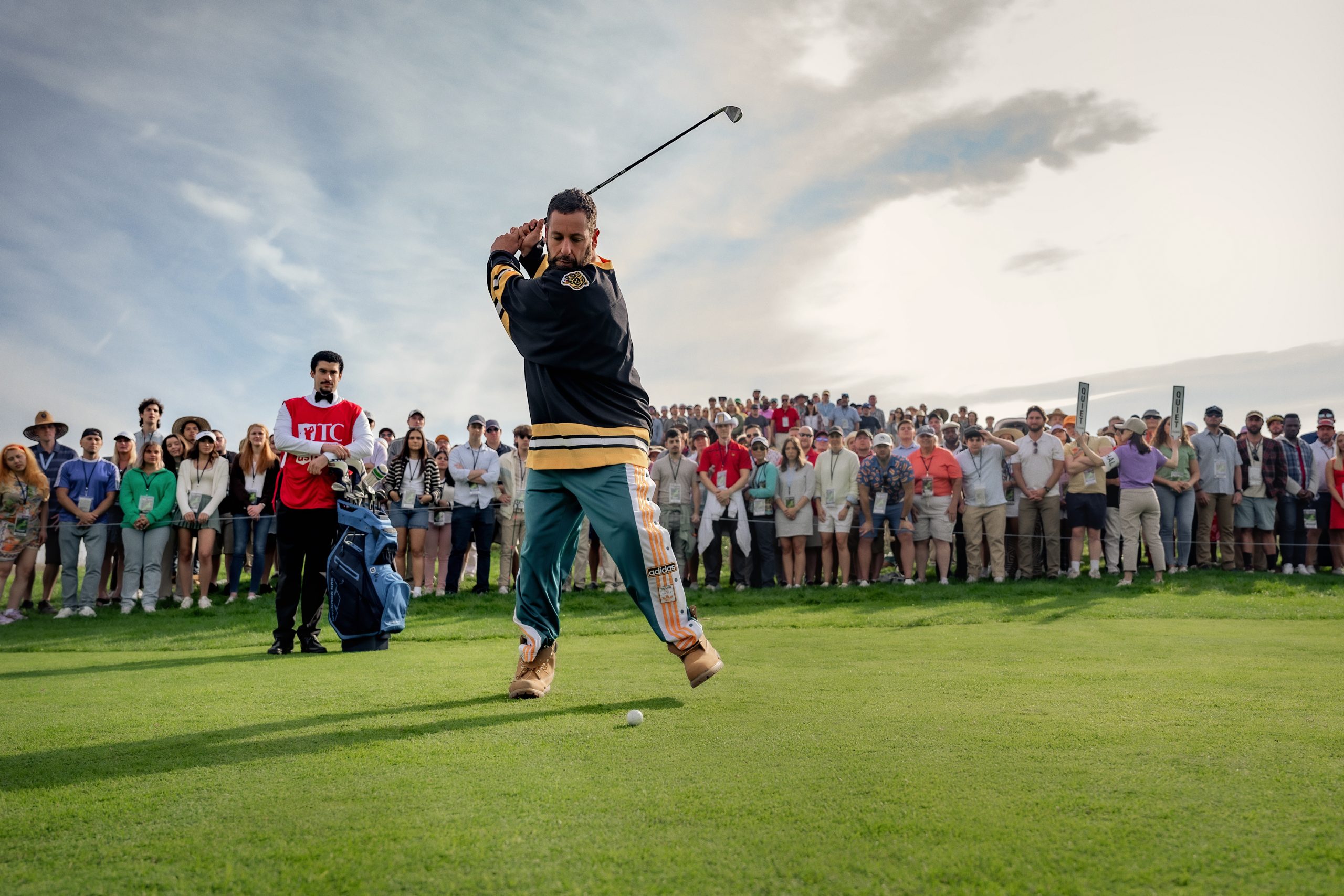 Um Maluco No Golfe 2 (Happy Gilmore 2) (L to R) Benito Antonio Martínez Ocasio as Busboy and Adam Sandler as Happy Gilmore in Happy Gilmore 2. Cr. Scott Yamano/Netflix © 2024.